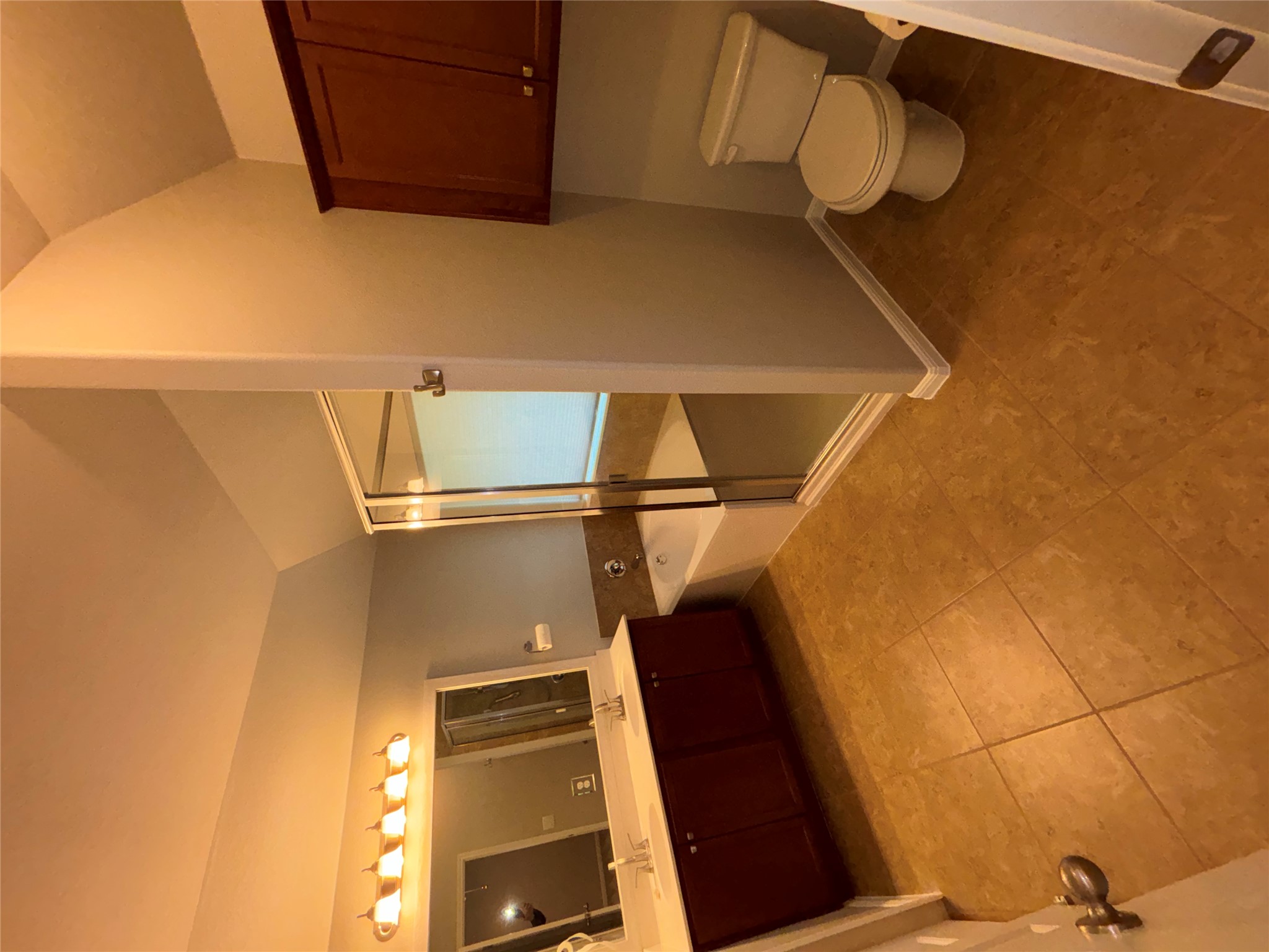 634 River Bluff Circle Georgetown, TX 78626 - Photo 24 of 37 Full bath with double vanity, vaulted ceiling, a shower stall, a garden tub, and light tile patterned floors