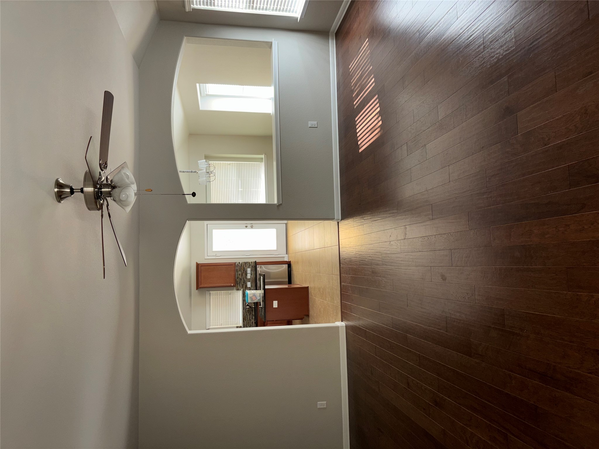 634 River Bluff Circle Georgetown, TX 78626 - Photo 5 of 37 Unfurnished living room with a ceiling fan, dark wood-style floors, and arched walkways