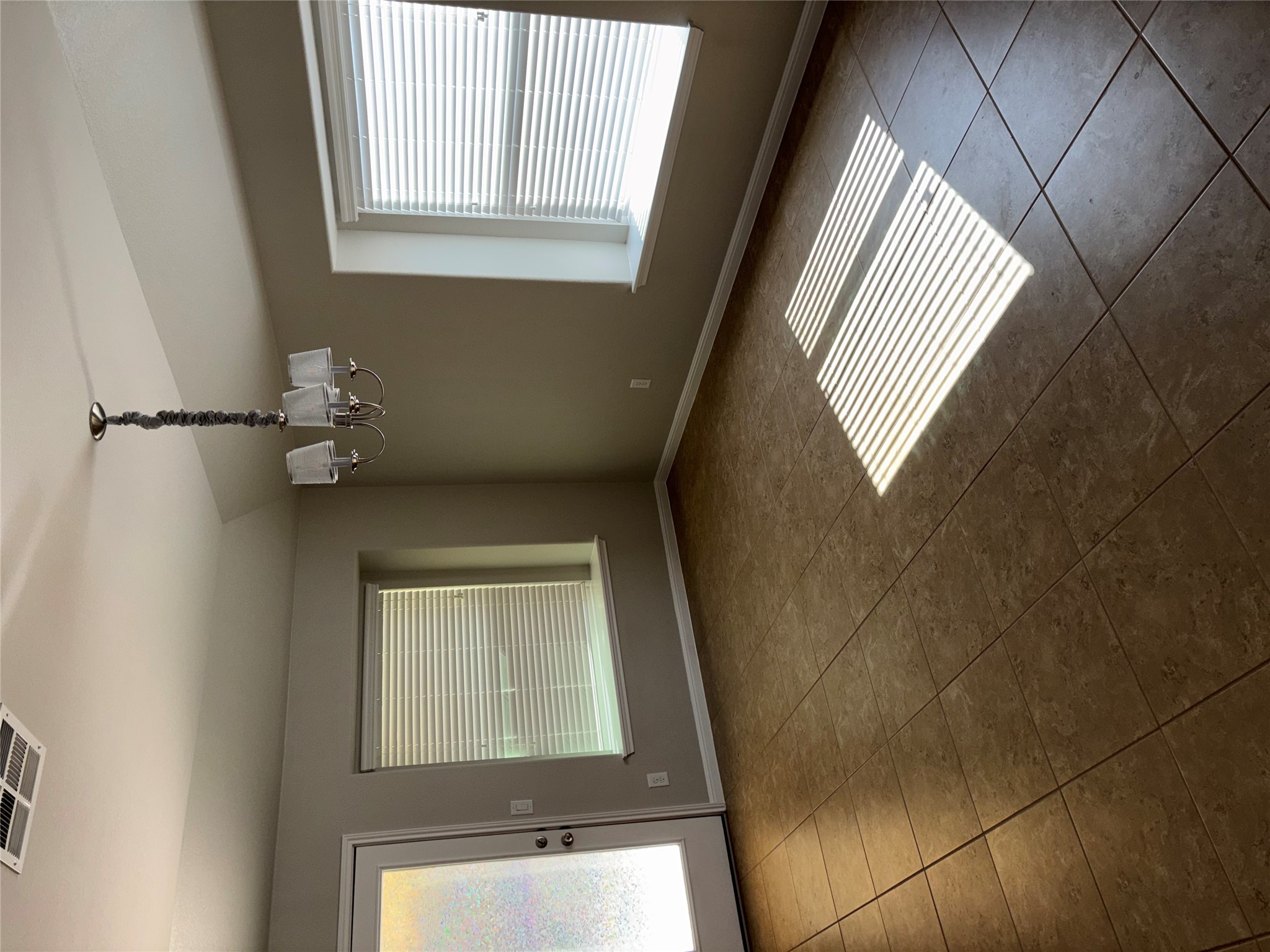 634 River Bluff Circle Georgetown, TX 78626 - Photo 8 of 37 Unfurnished room with a chandelier, lofted ceiling, and dark tile patterned flooring