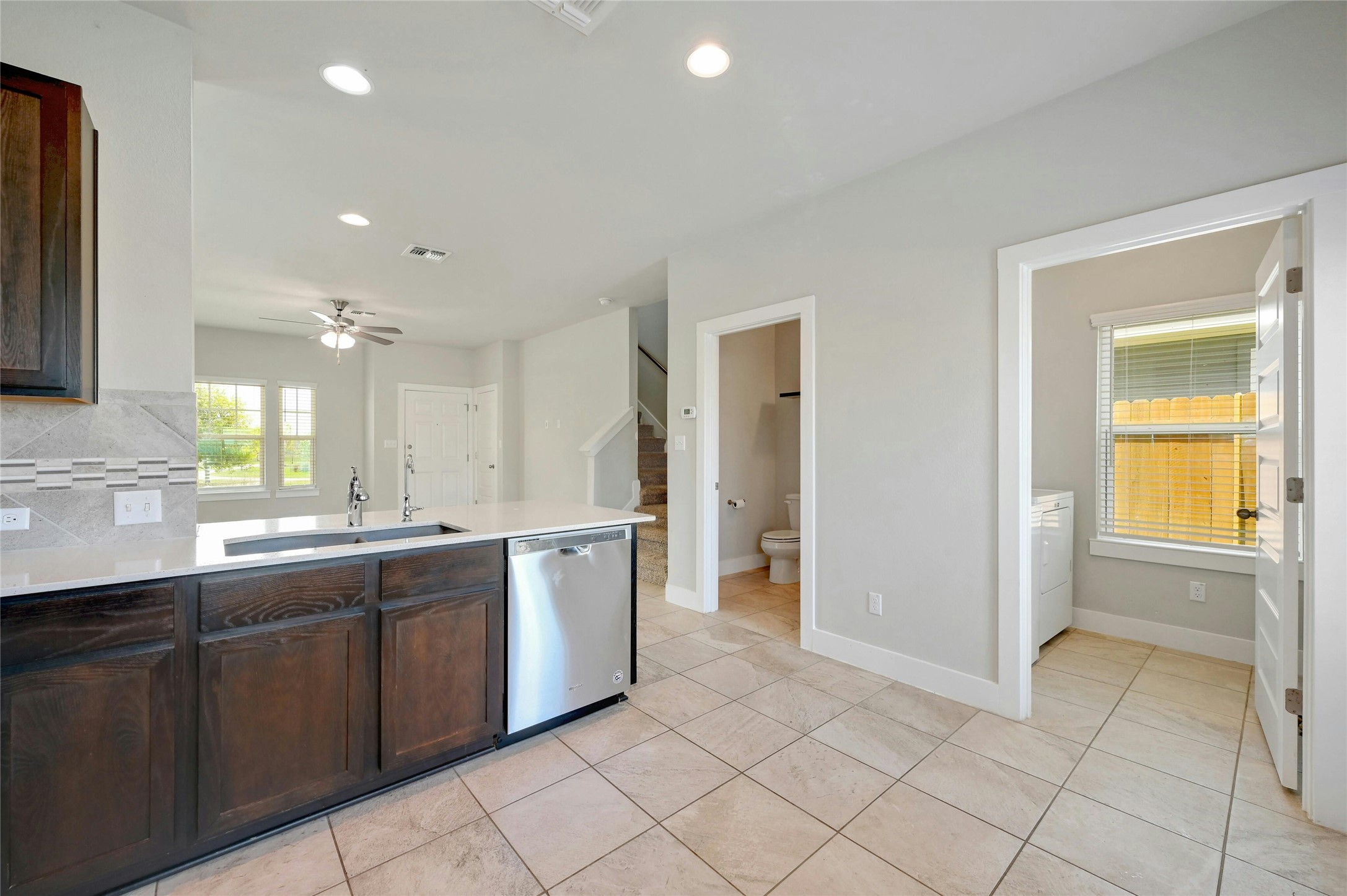 121 Switchgrass Street San Marcos, TX 78666 - Photo 16 of 33 View from the kitchen looking towards the laundry room / pantry on the right and half bath on the left.