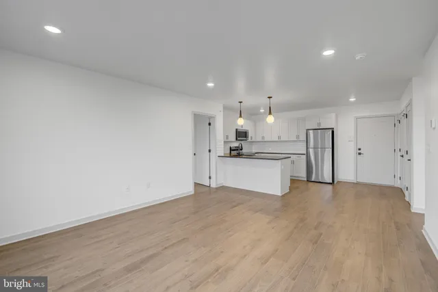 a view of a kitchen with a sink and a refrigerator
