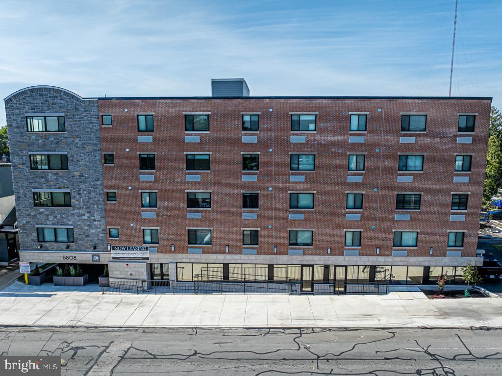 6808 Ridge Avenue, Unit 218 Philadelphia, PA 19128 - Photo 10 of 10 a front view of a building with glass windows