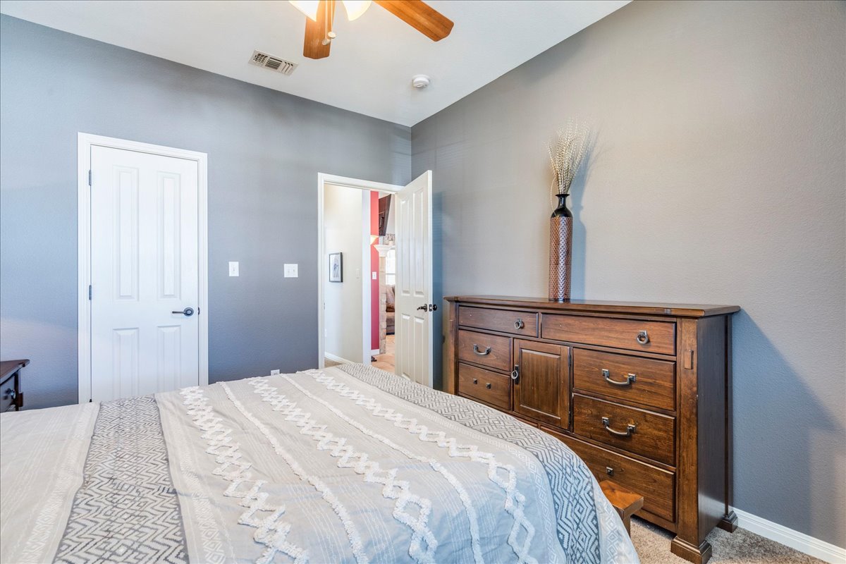 11 Rhapsody Lane Wimberley, TX 78676 - Photo 19 of 35 a bedroom with a bed and a dresser