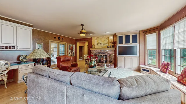 a kitchen with stainless steel appliances kitchen island granite countertop a sink a stove and a wooden cabinets