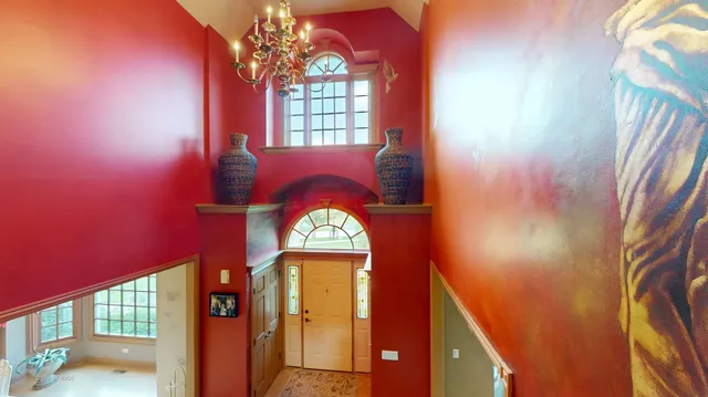 a living room with furniture and floor to ceiling windows