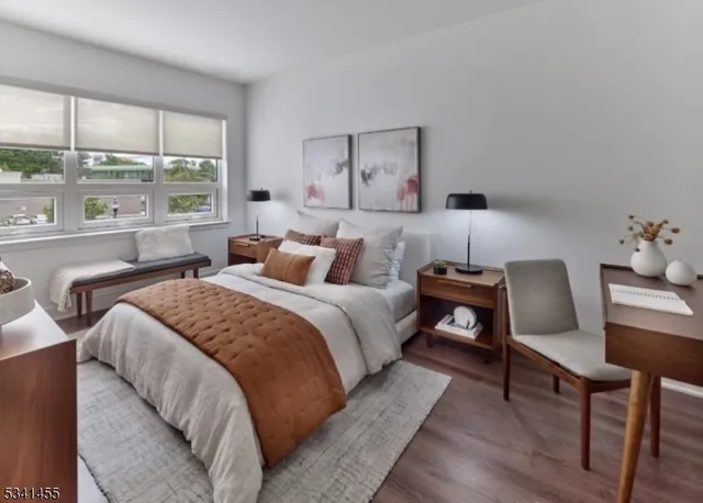 a bedroom with a bed a table and window