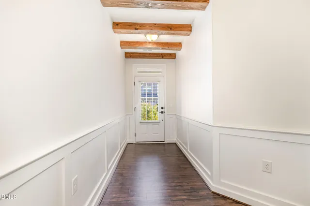 a view of hallway with wooden floor