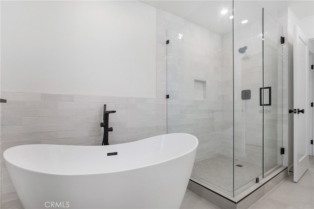 6265 Majorca Circle Long Beach, CA 90803 - Photo 18 of 38 a white bath tub sitting in a bathroom shower