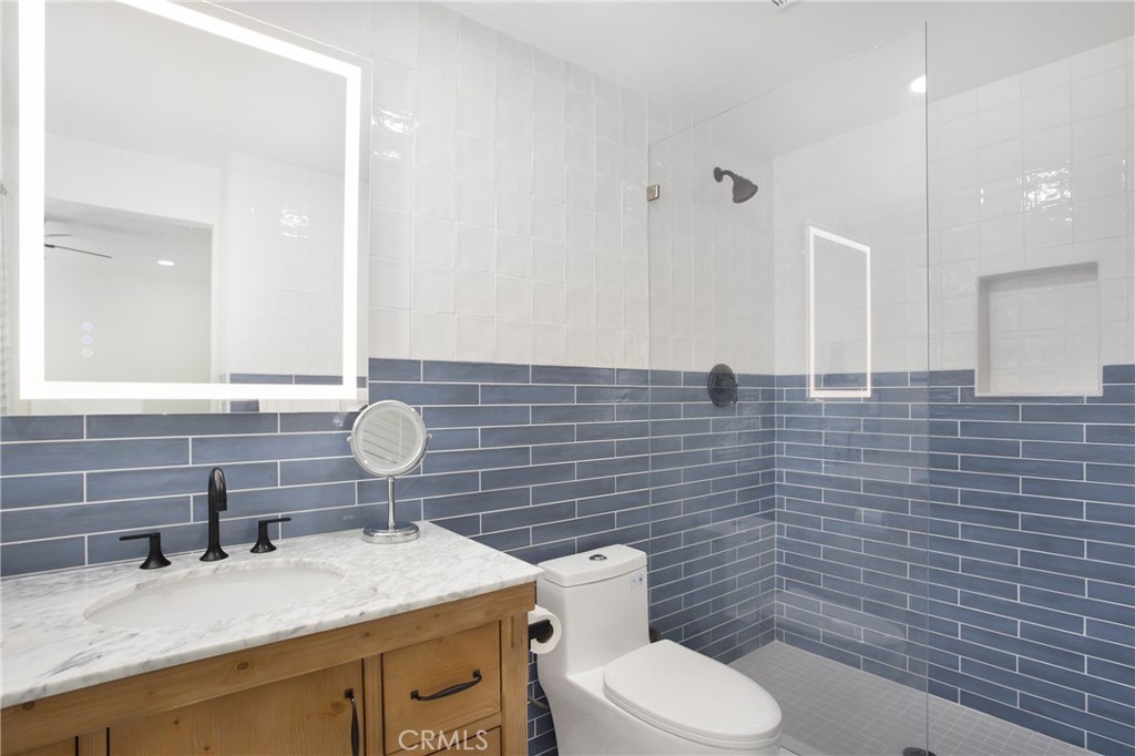 6265 Majorca Circle Long Beach, CA 90803 - Photo 23 of 38 a bathroom with a granite countertop toilet sink and mirror