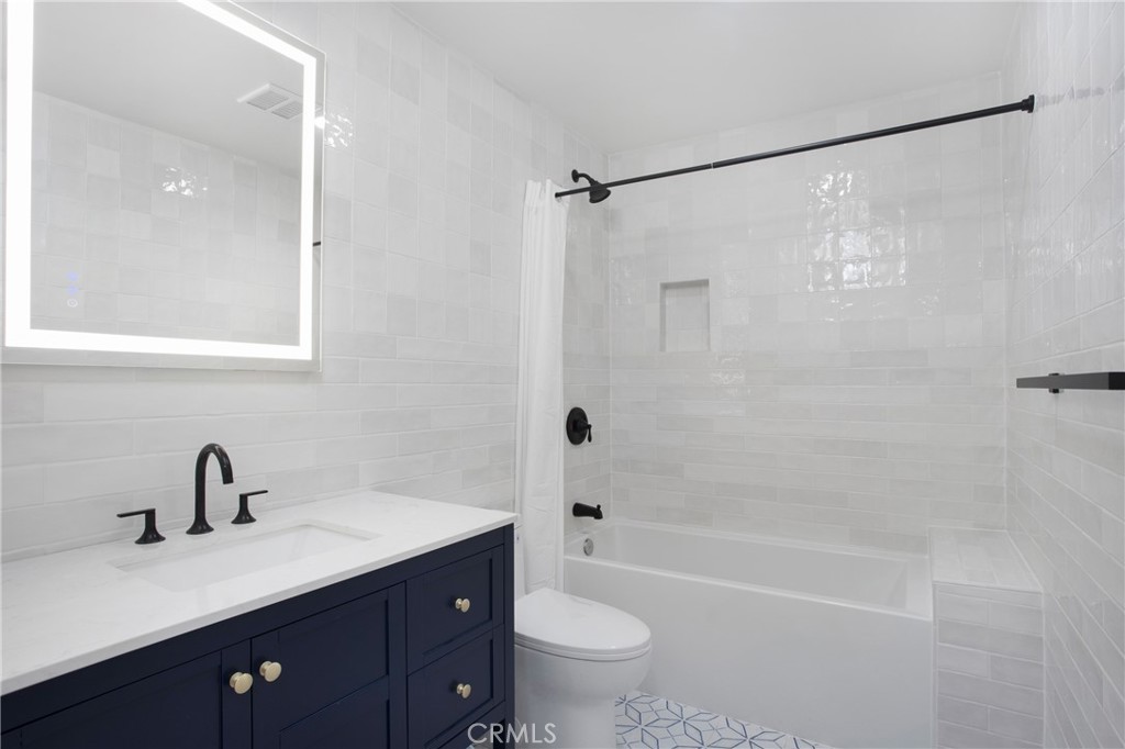 6265 Majorca Circle Long Beach, CA 90803 - Photo 25 of 38 a bathroom with a bathtub shower sink vanity mirror and toilet