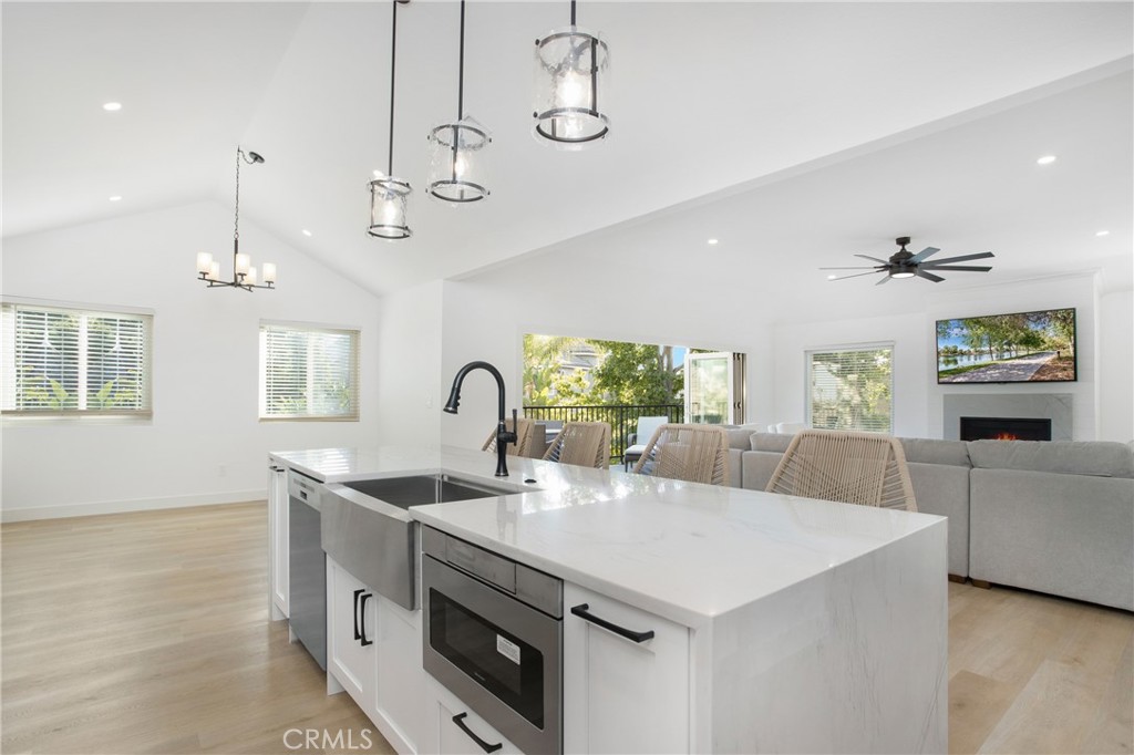 6265 Majorca Circle Long Beach, CA 90803 - Photo 4 of 38 a very nice looking kitchen with granite countertop a stove a sink a window and chairs