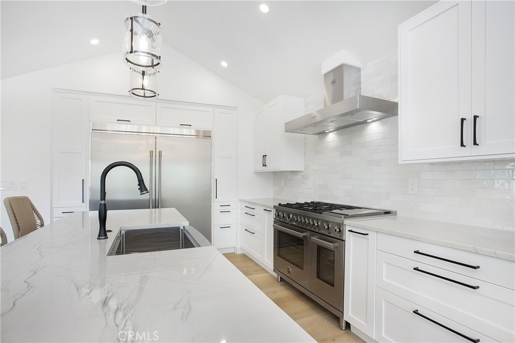 6265 Majorca Circle Long Beach, CA 90803 - Photo 5 of 38 a kitchen with stainless steel appliances a stove a sink and cabinets