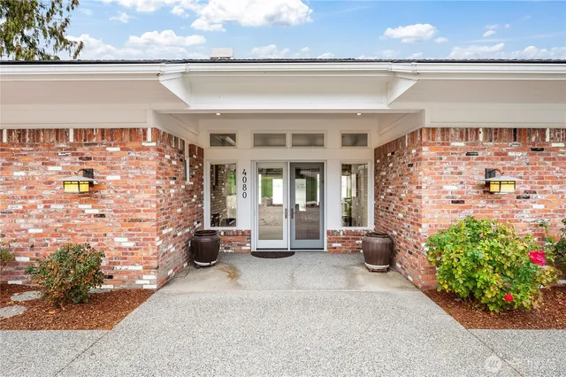 an aerial view of a house with swimming pool garden and lake view