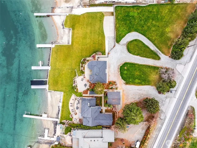 a view of a swimming pool with lawn chairs under an umbrella