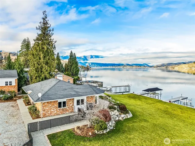 a view of a lake with a table and chairs