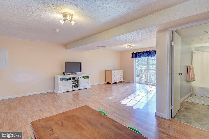 8269 Sycamore Road Lusby, MD 20657 - Photo 17 of 26 Family Room Lower Level -- Laminate is Brand New!