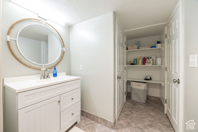 2280 South 450 West Perry, UT 84302 - Photo 12 of 38 Bathroom with vanity, light tile patterned floors, and a textured ceiling