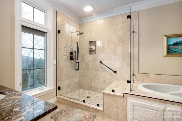 a bathroom with a granite countertop sink a toilet and shower
