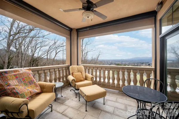 a roof deck with couches and wooden floor
