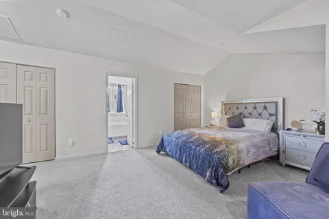 a bedroom with a bed and a lamp
