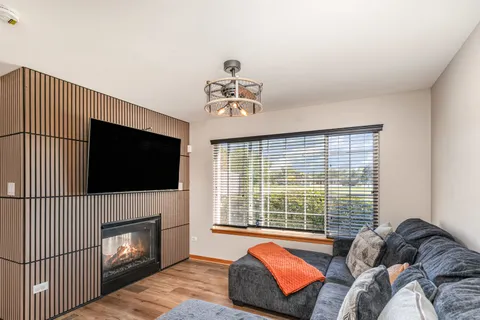 a living room with furniture fireplace and flat screen tv