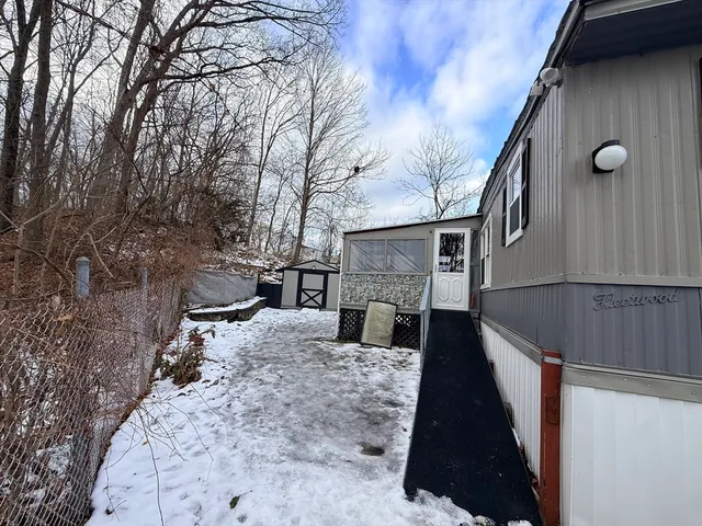 a view of house with backyard and trees