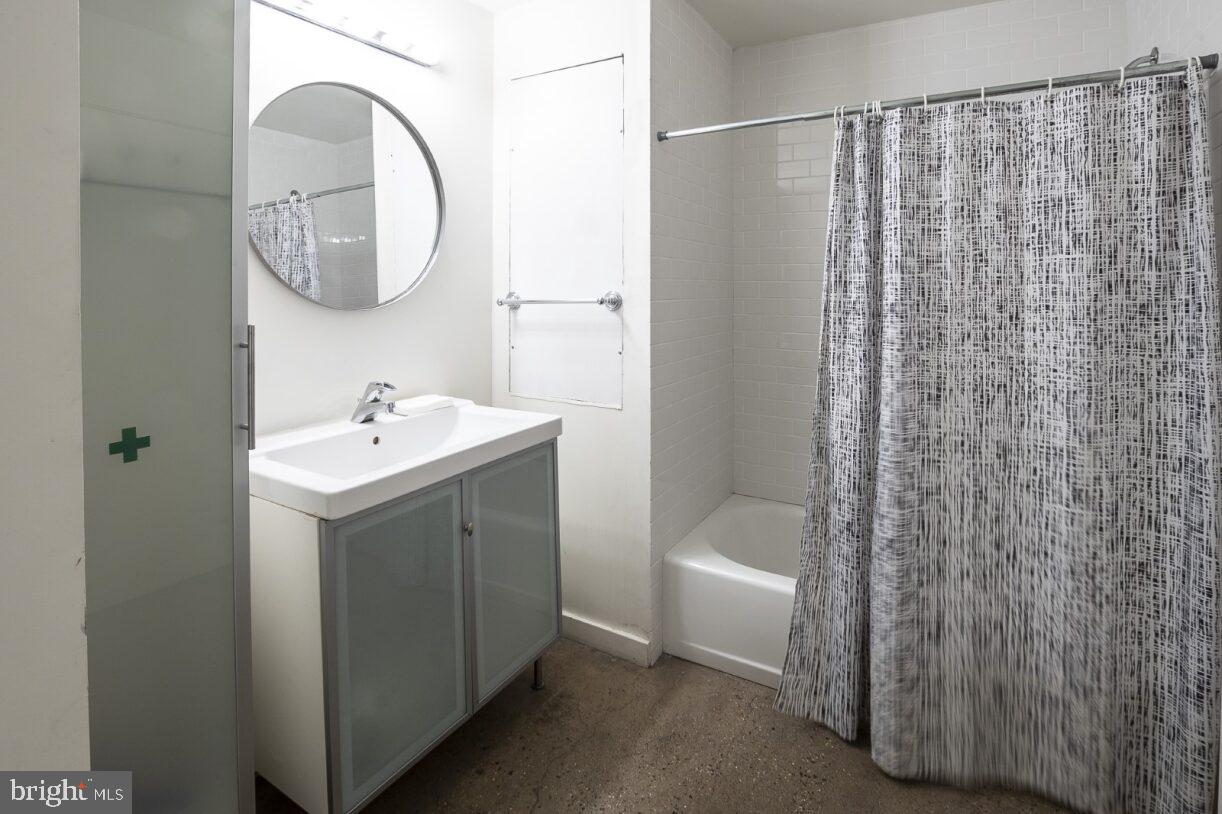 20 North 3rd Street, Unit 302 Philadelphia, PA 19106 - Photo 13 of 17 a bathroom with a sink a toilet and shower curtain