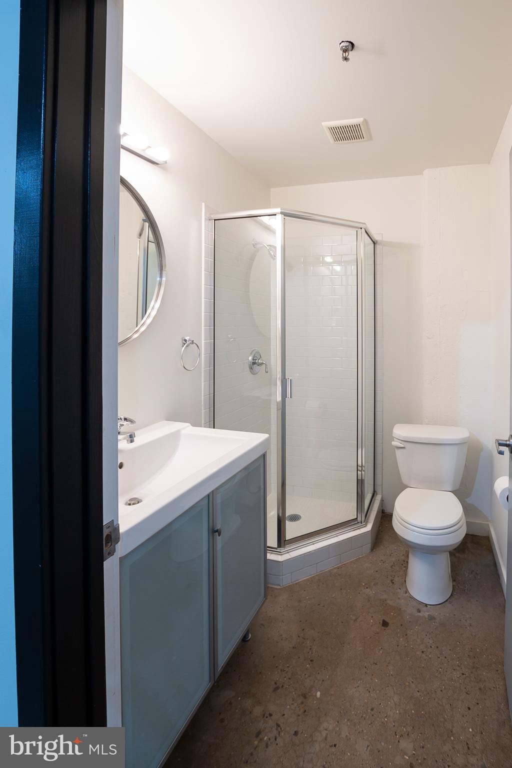 20 North 3rd Street, Unit 302 Philadelphia, PA 19106 - Photo 15 of 17 a bathroom with a granite countertop sink toilet and shower