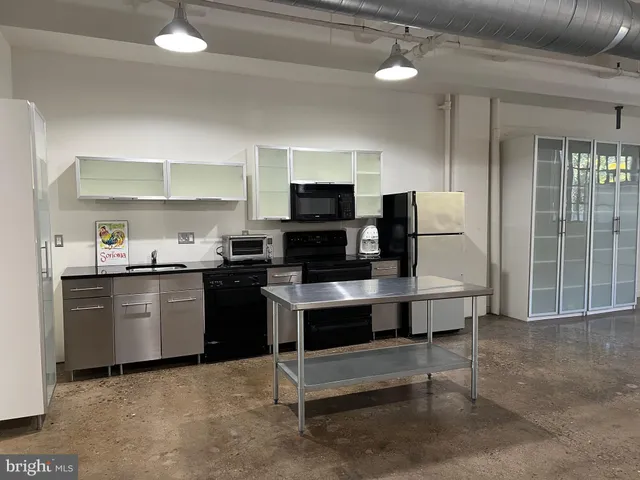 a kitchen with stainless steel appliances a refrigerator and a stove top oven