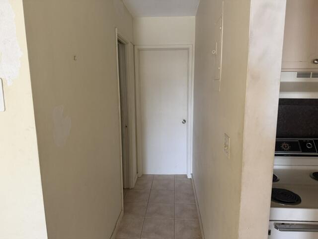 660 Glouchester Street, Unit 206 Boca Raton, FL 33487 - Photo 10 of 13 a view of a kitchen from the hallway