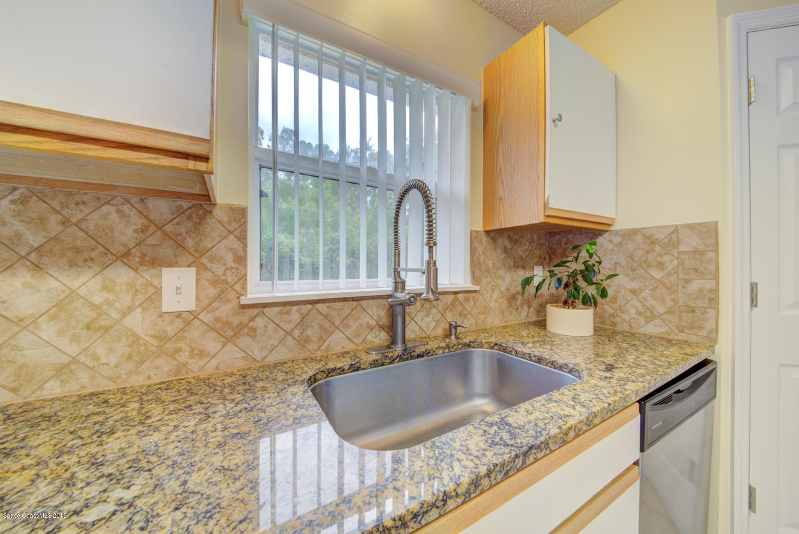 787 Raleigh Road Southeast Palm Bay, FL 32909 - Photo 14 of 51 Kitchen With Tile Backsplash