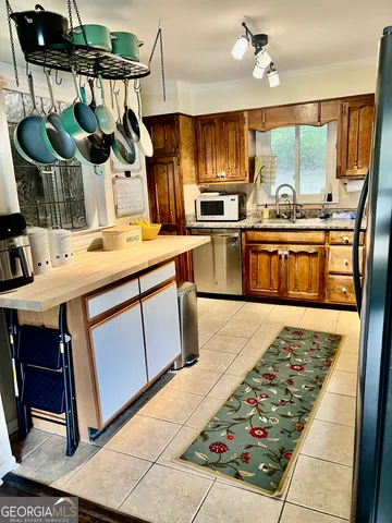 a kitchen with a stove a sink and a refrigerator