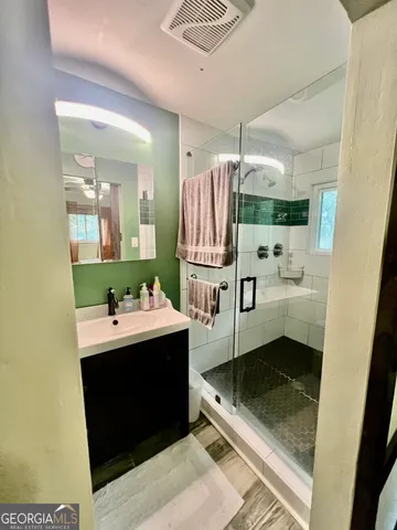 a bathroom with a sink a toilet and mirror