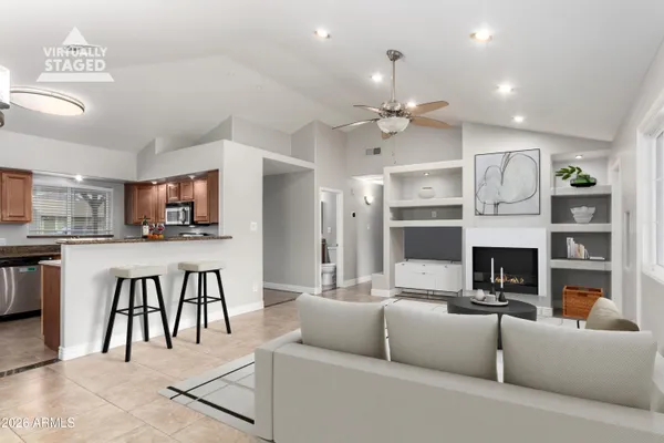 a living room with furniture a fireplace and a flat screen tv