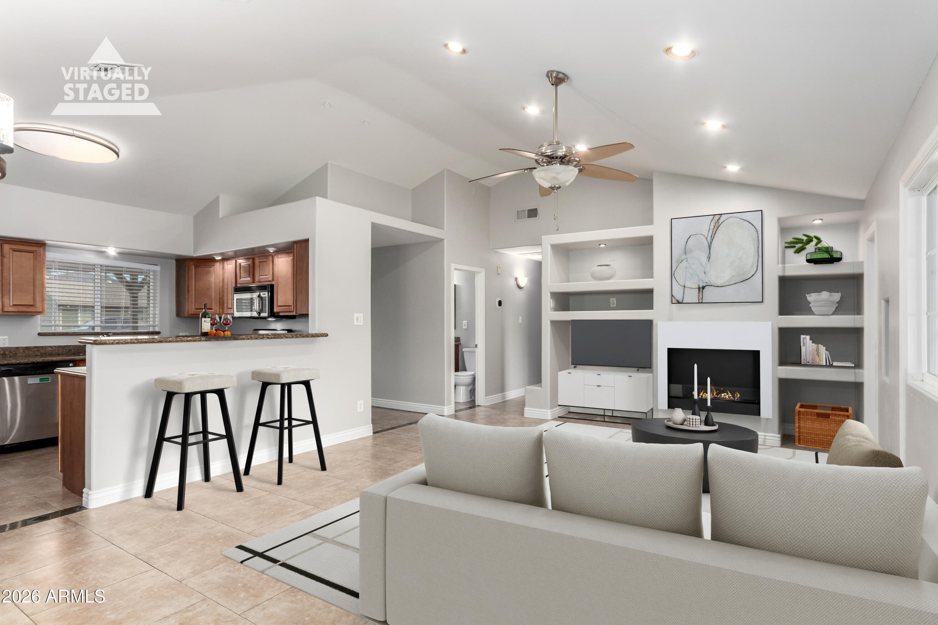 a living room with furniture a fireplace and a flat screen tv