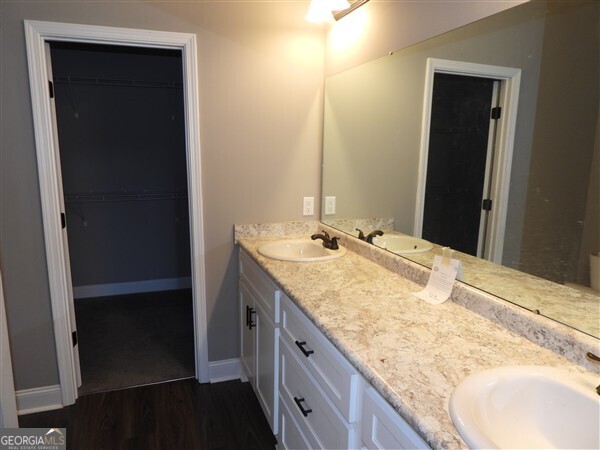 5915 Rye Patch Road Ludowici, GA 31316 - Photo 22 of 25 a bathroom with a granite countertop sink and a mirror