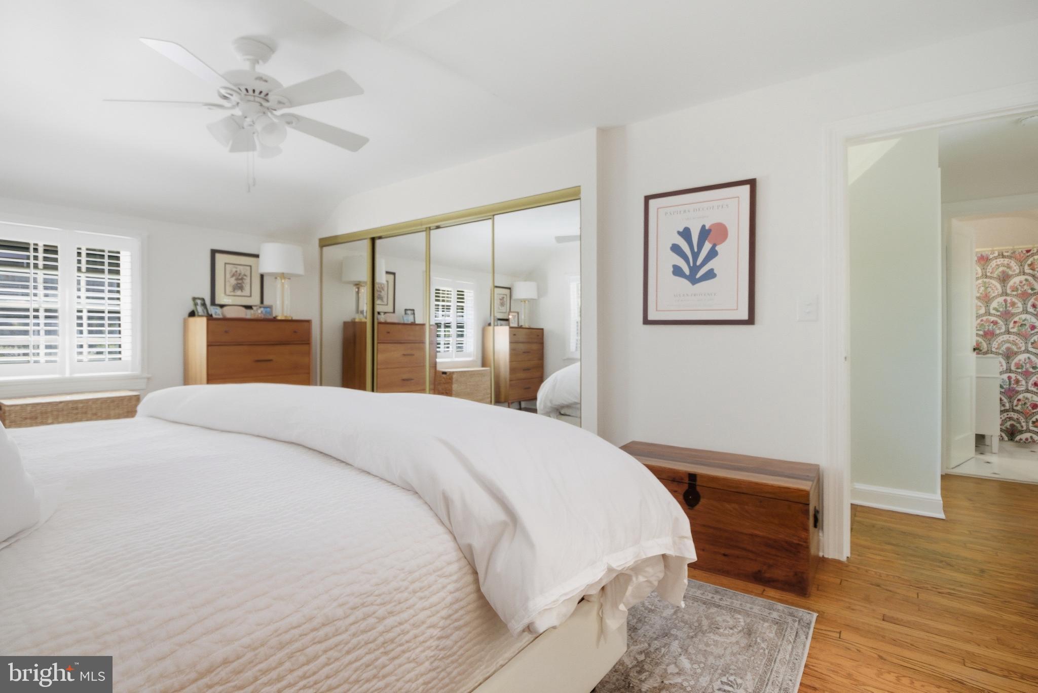 6032 Grove Drive Alexandria, VA 22307 - Photo 18 of 40 a spacious bedroom with a bed and a dresser with wooden floor