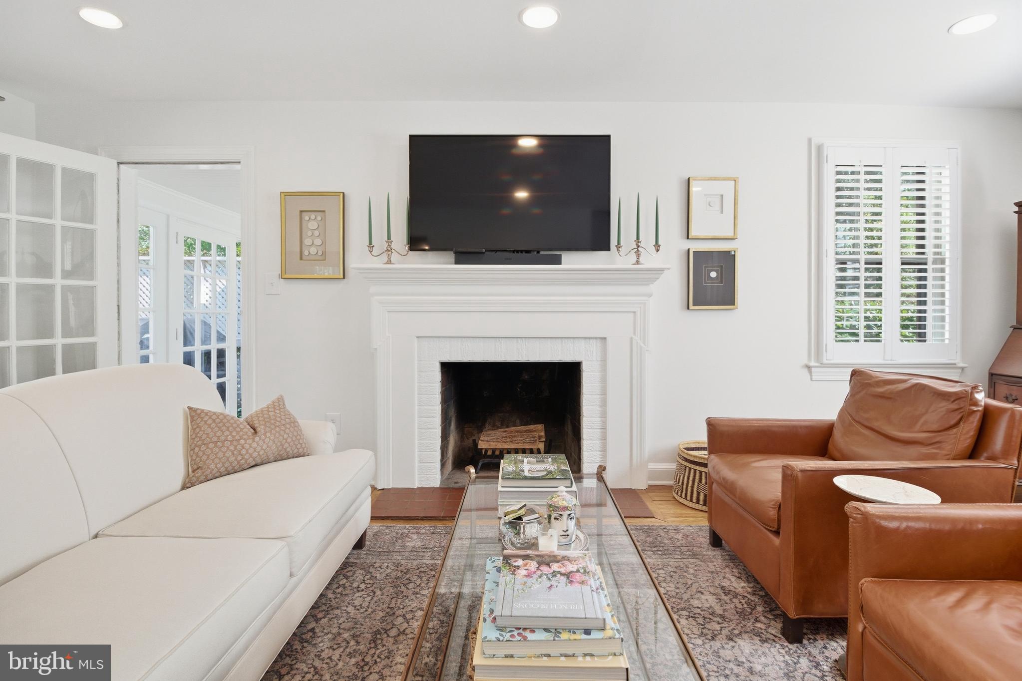 6032 Grove Drive Alexandria, VA 22307 - Photo 2 of 40 a living room with furniture a flat screen tv and a fireplace