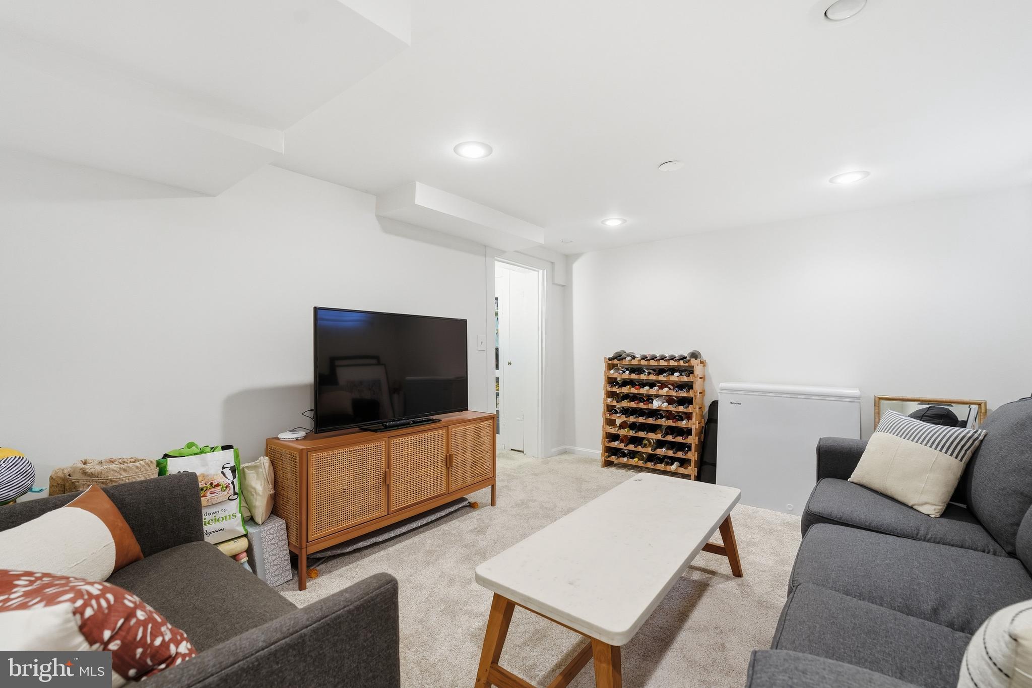 6032 Grove Drive Alexandria, VA 22307 - Photo 25 of 40 a living room with furniture and a flat screen tv