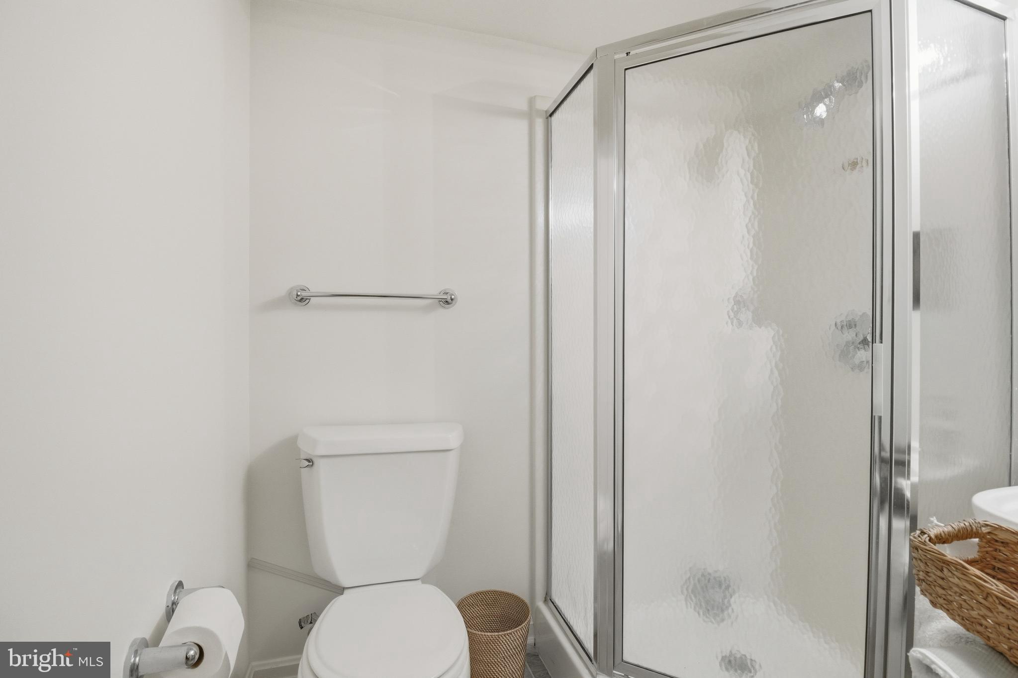 6032 Grove Drive Alexandria, VA 22307 - Photo 27 of 40 a white toilet sitting next to a bathroom sink