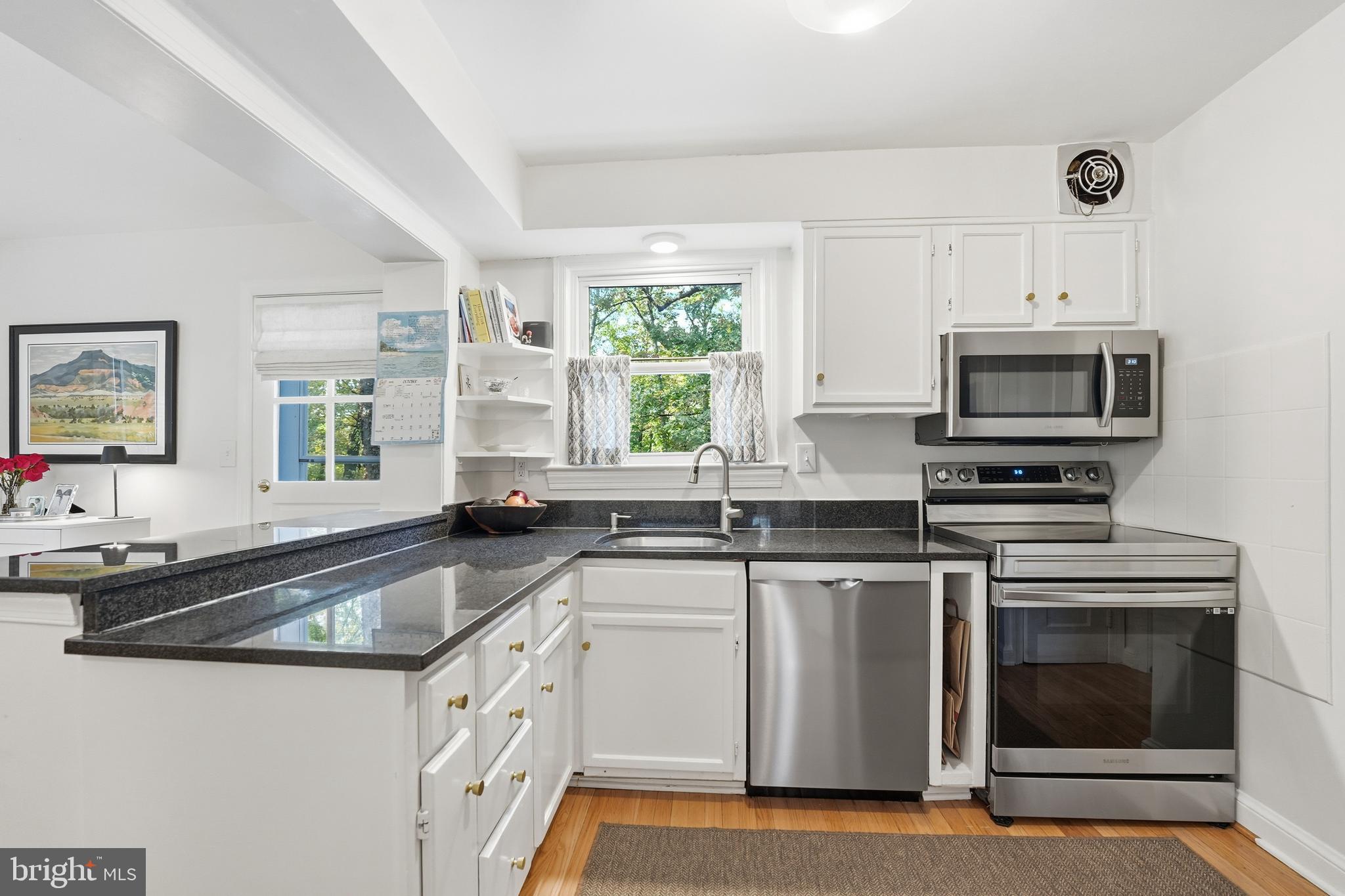 6032 Grove Drive Alexandria, VA 22307 - Photo 7 of 40 a kitchen with granite countertop a sink stainless steel appliances and cabinets