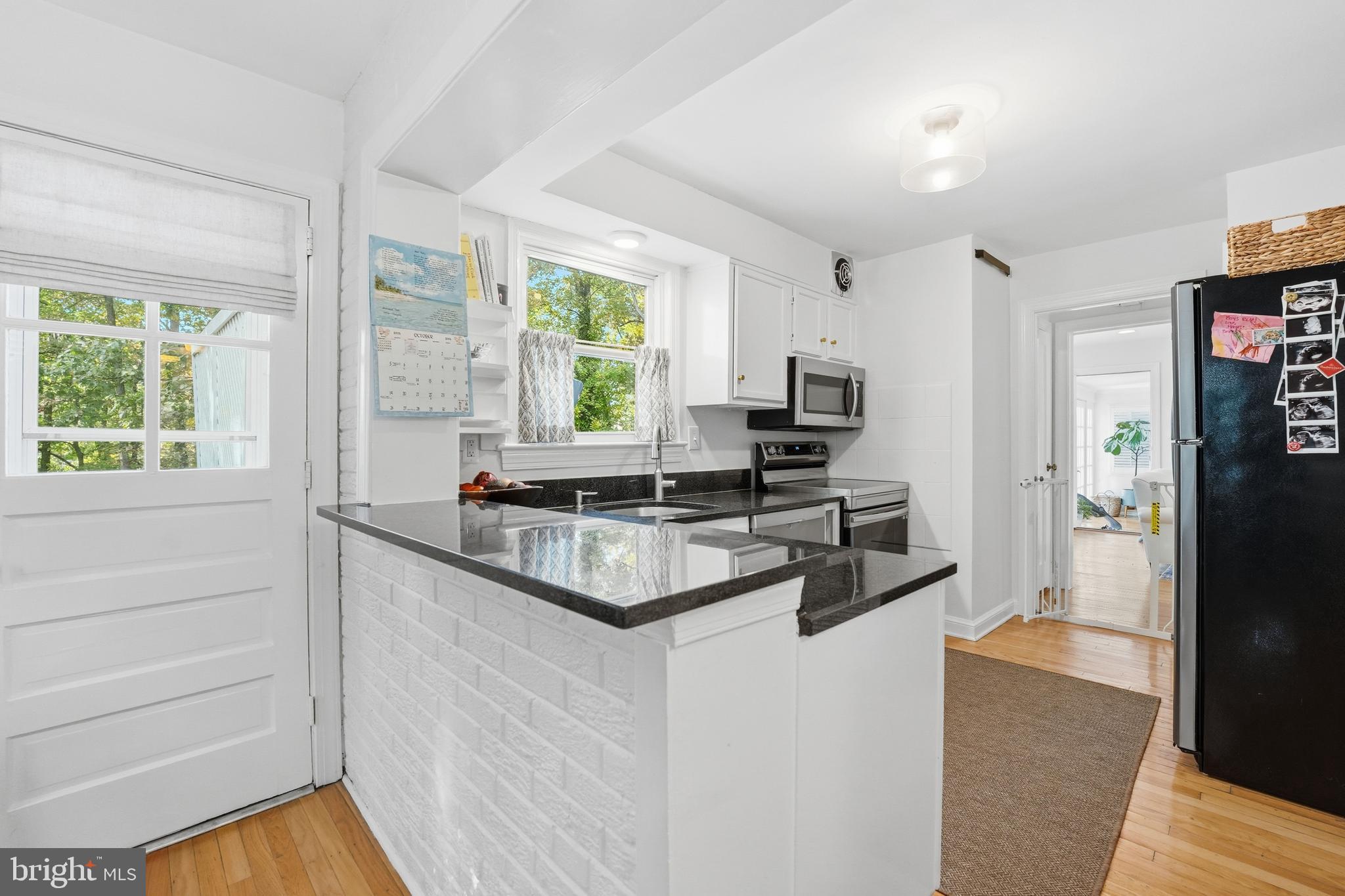 6032 Grove Drive Alexandria, VA 22307 - Photo 8 of 40 a kitchen with stainless steel appliances granite countertop a stove and a refrigerator