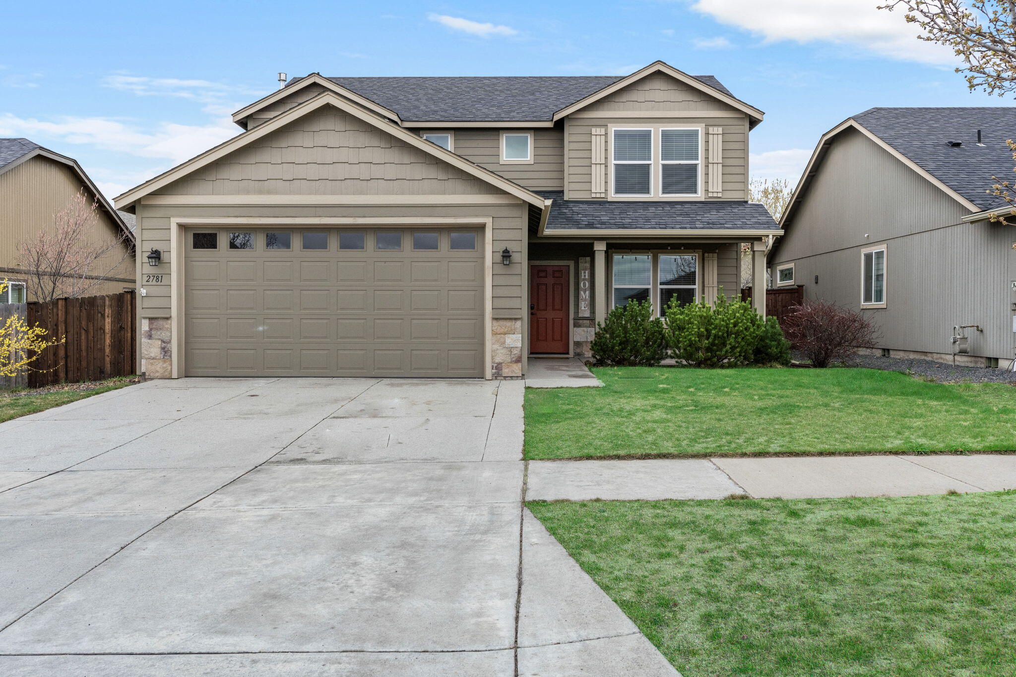 2781 Northeast Spring Water Place Bend, OR 97701 - Photo 20 of 23 a front view of a house with a yard and garage