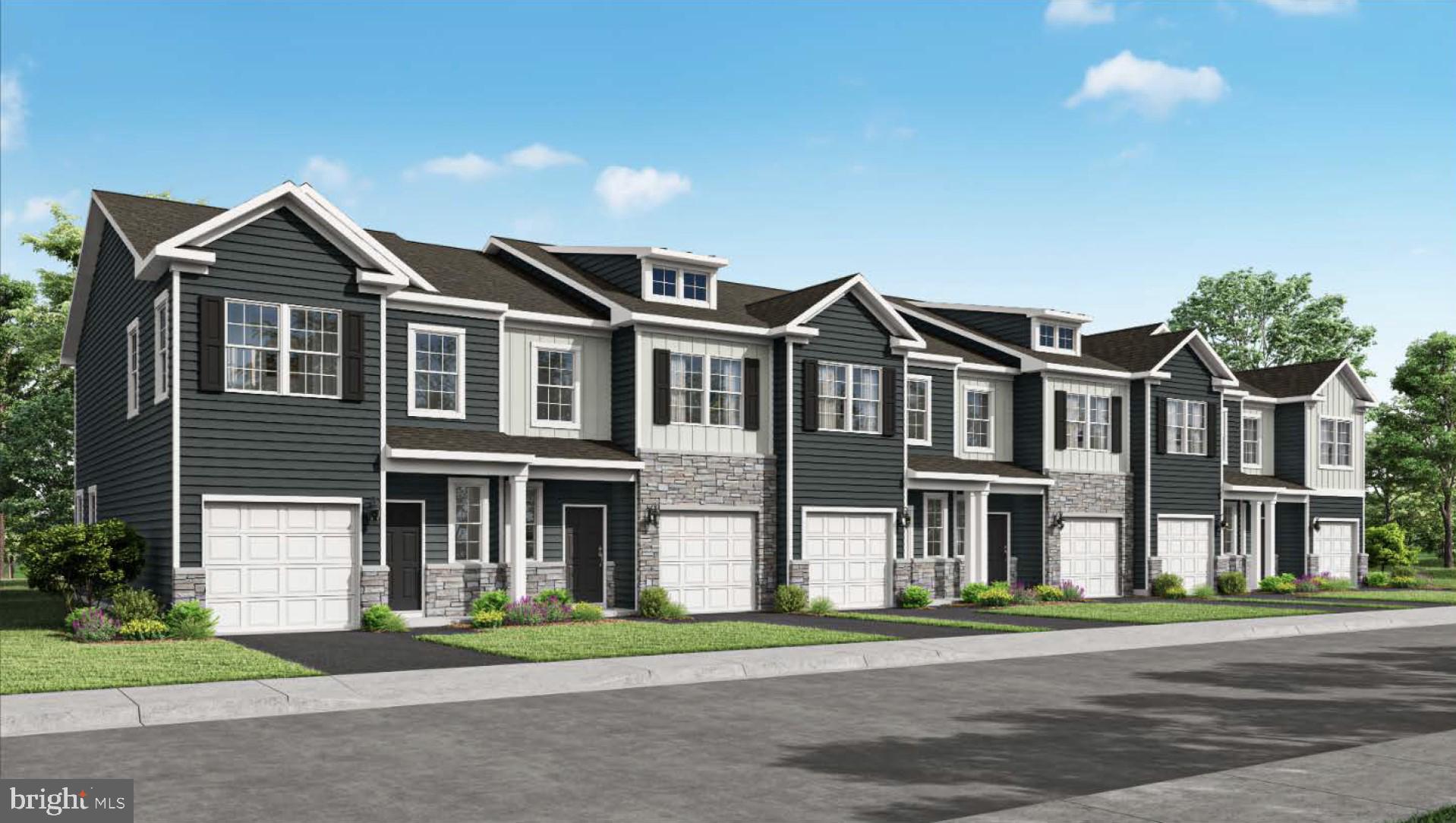 a front view of a residential apartment building with a yard