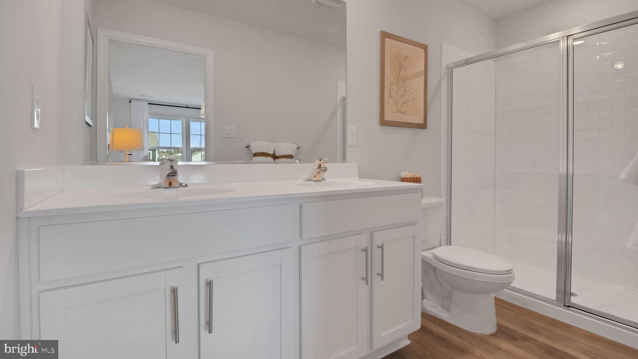 8 Whaler Drive Runnemede, NJ 08078 - Photo 13 of 24 a bathroom with a sink a toilet and a mirror