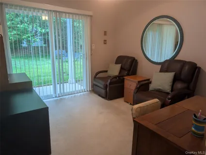 a living room with furniture and a mirror