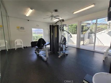 a view of a livingroom with furniture wooden floor and a large window