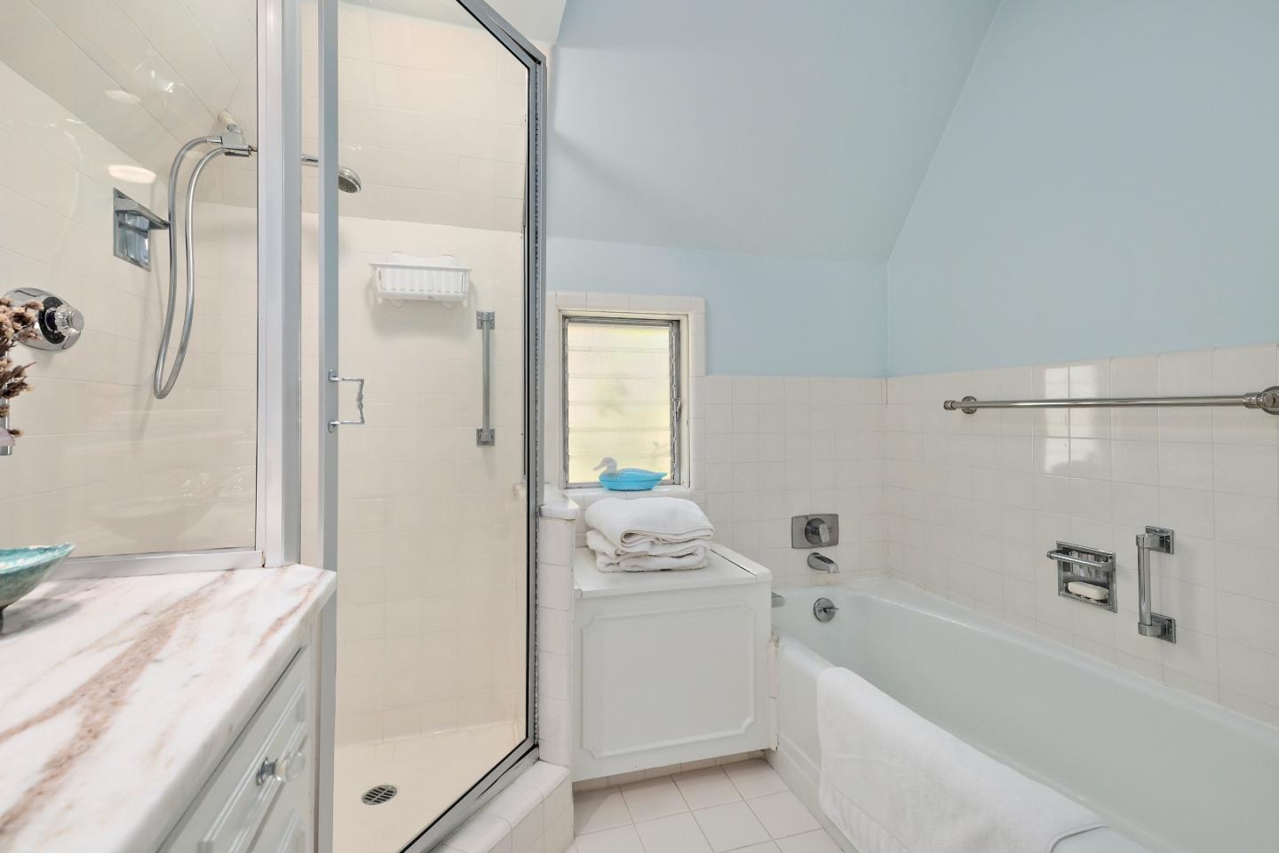 72 Winchester Drive Atherton, CA 94027 - Photo 26 of 50 a bathroom with a granite countertop sink a bathtub and a shower