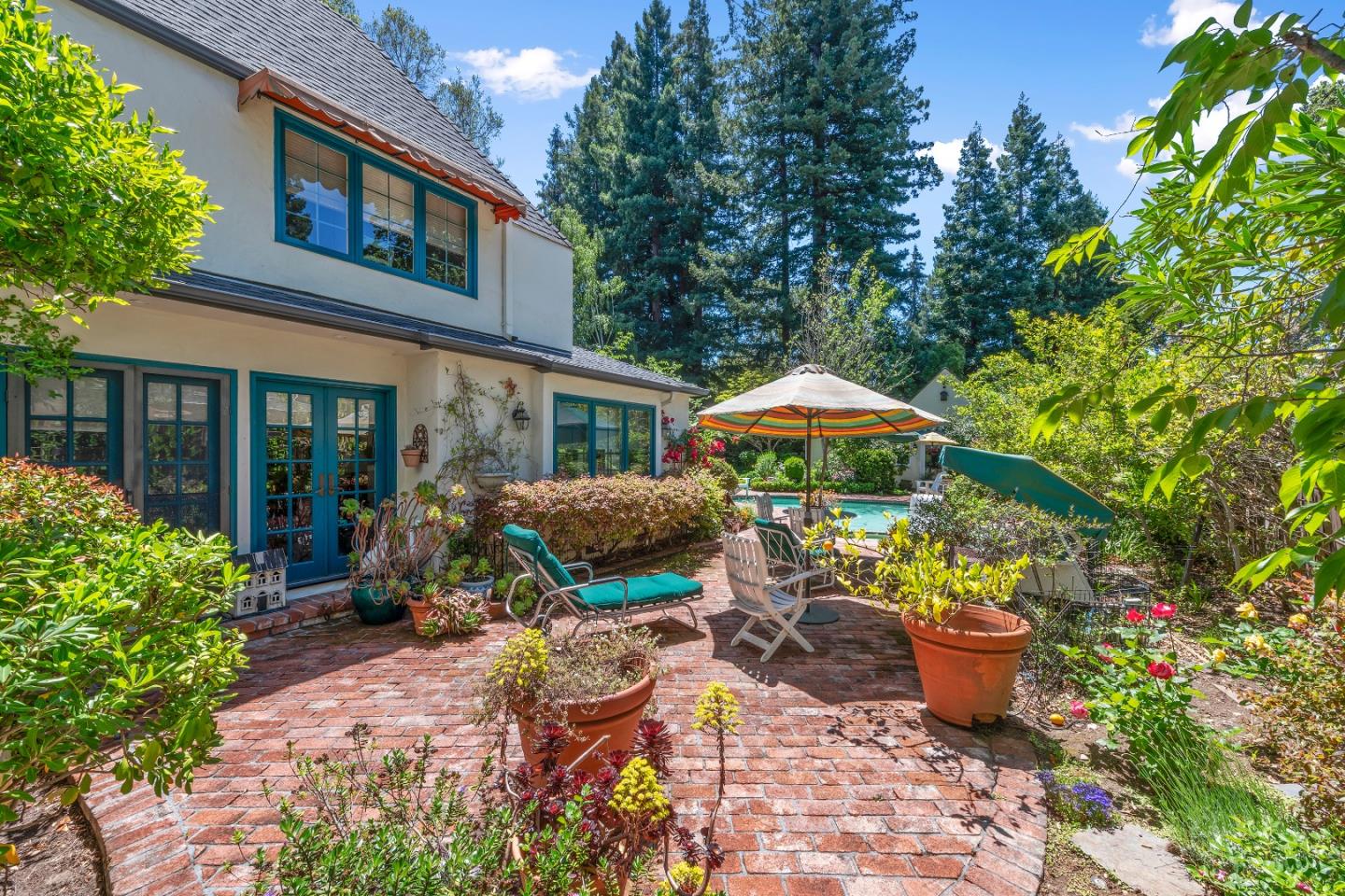 72 Winchester Drive Atherton, CA 94027 - Photo 42 of 50 a view of a patio with table and chairs under an umbrella