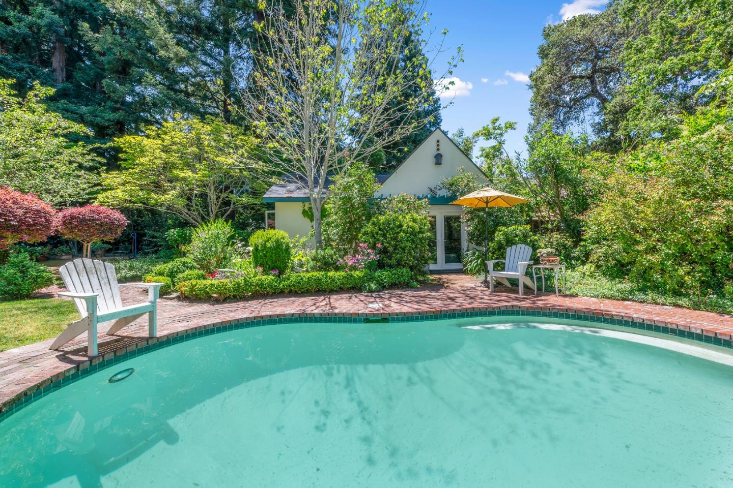 72 Winchester Drive Atherton, CA 94027 - Photo 43 of 50 a view of a patio with table and chairs under an umbrella